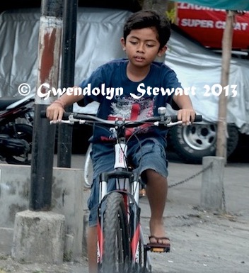 Boy Riding a Bike on Bali, Indonesia, Photographed by
Gwendolyn Stewart, c. 2014; All Rights Reserved